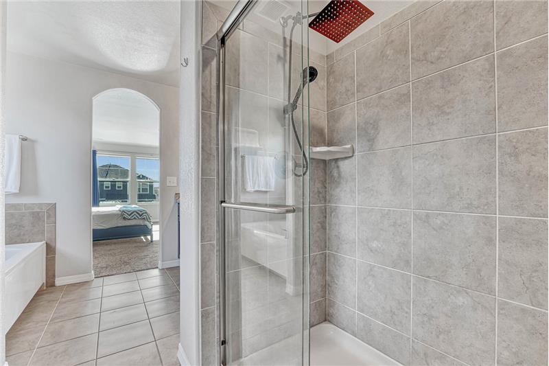 Upper level Primary Bathroom tiled shower with upgraded rain shower head.
