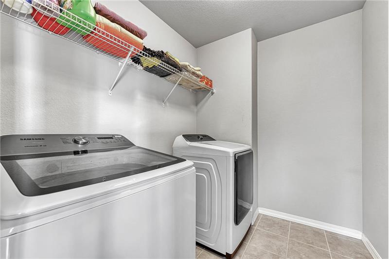 Upper level Laundry Room with washer and dryer that stay.