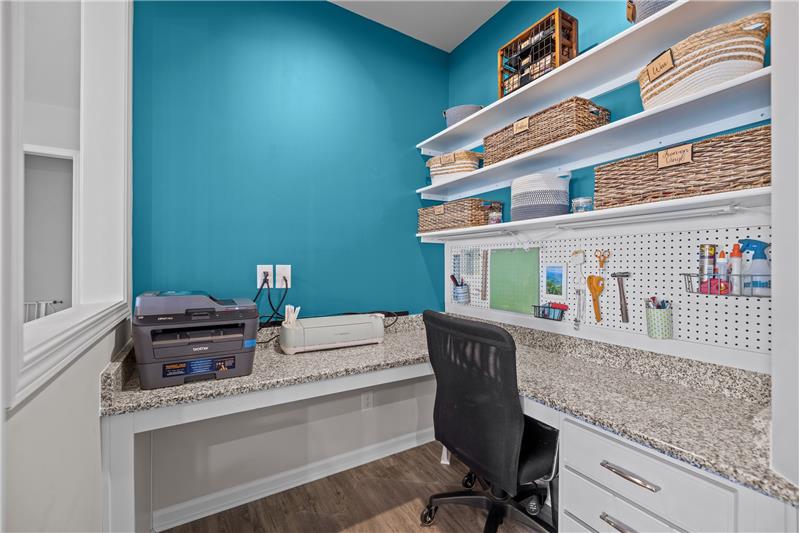 Office with built-in desk, shelves, storage