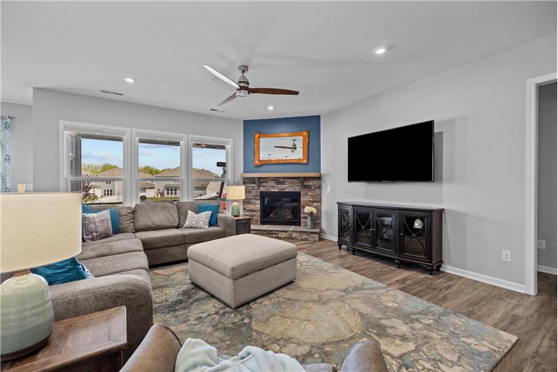 Great room with stone fireplace with raised hearth