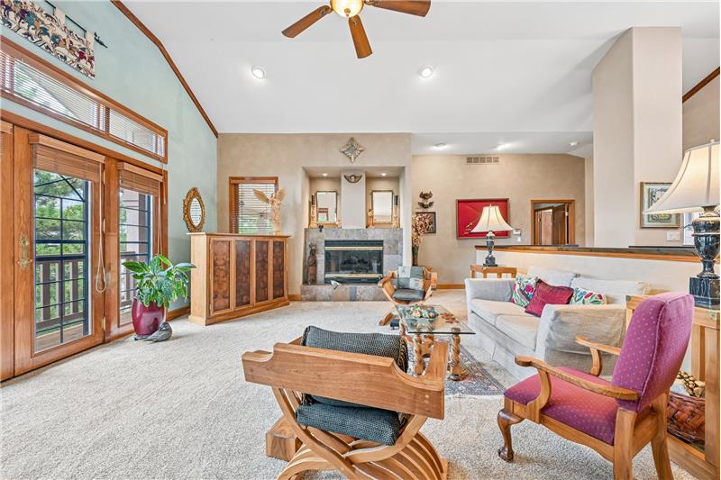Great room with gas fireplace and door to cover deck