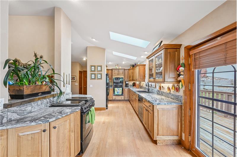 Kitchen, with door to deck at right