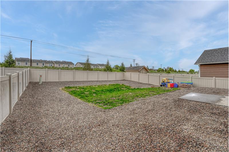 Low maintenance fenced backyard with auto sprinklers