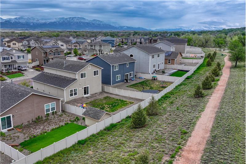 Aerial view of home and the open space behind the house offering trails, frisbee golf, and privacy.