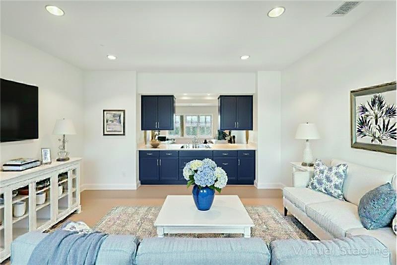 Lower level entertainment room with wet bar (digitally altered)