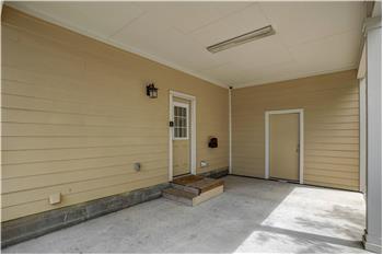 Carport with additional storage. Does have steps from carport into home.