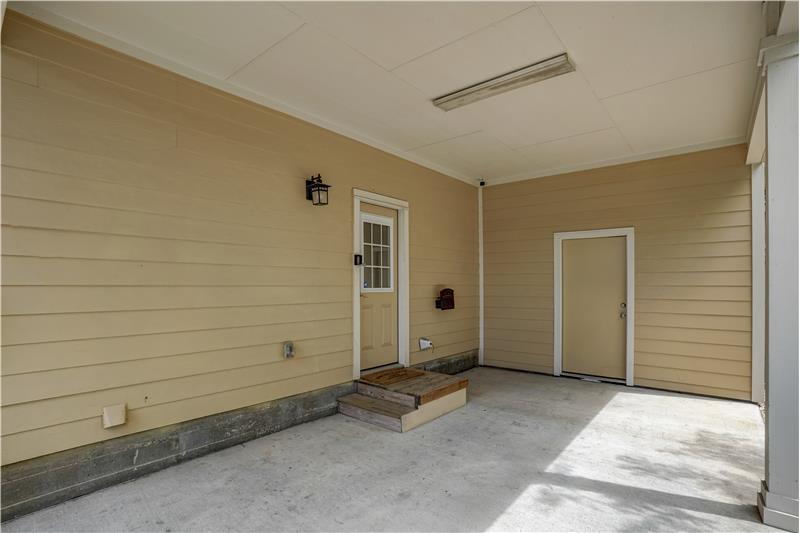 Carport with additional storage. Does have steps from carport into home.