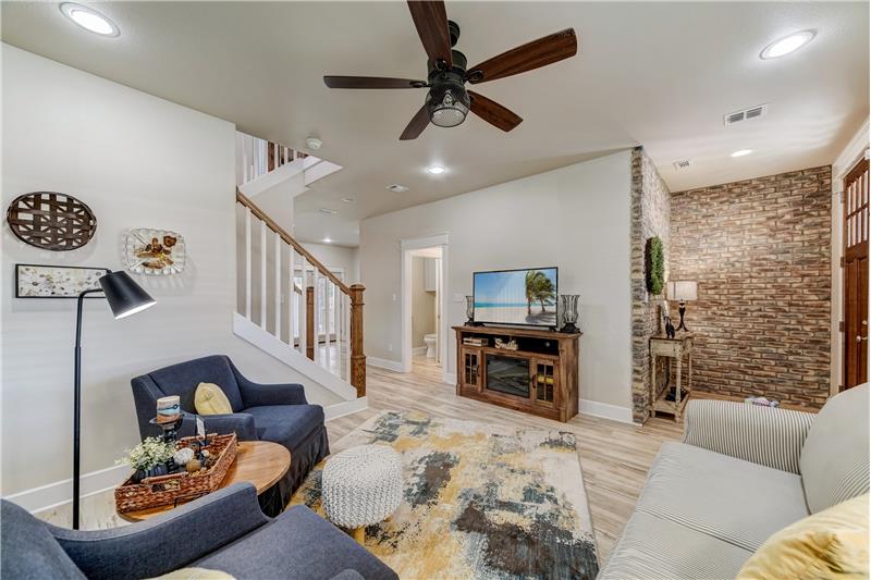 Living space facing front door. Decorative brick wall in entry.