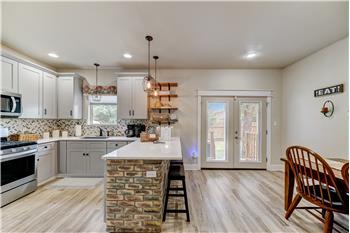 Kitchen with decorative brick breakfast bar and dining area.