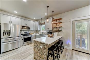 Kitchen with stainless steel appliances. Gas range, garbage disposal, dishwasher.