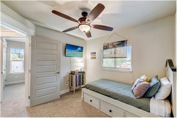 Secondary bedroom with spacious closet space and natural light.