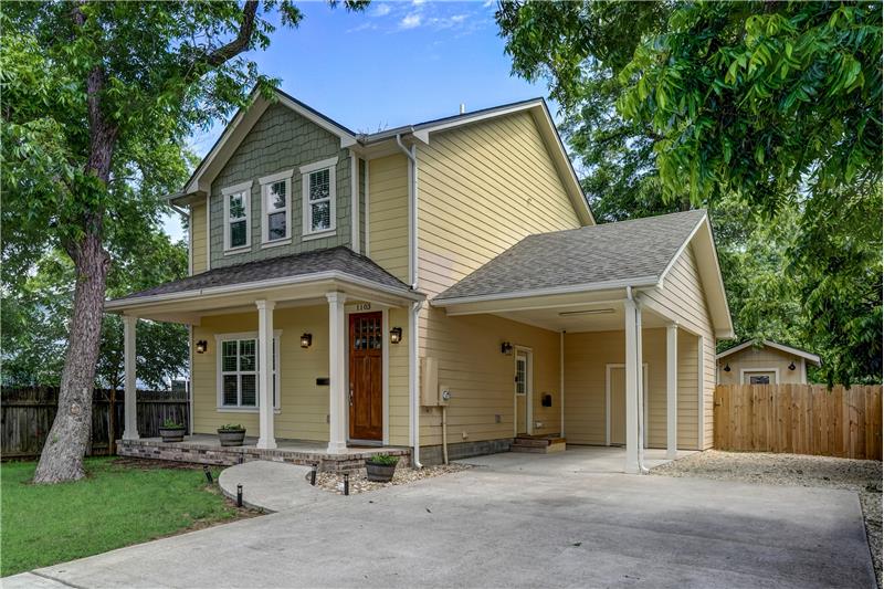 Front of home with carport and extra parking.