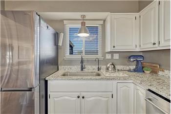 Kitchen sink with outdoor views.