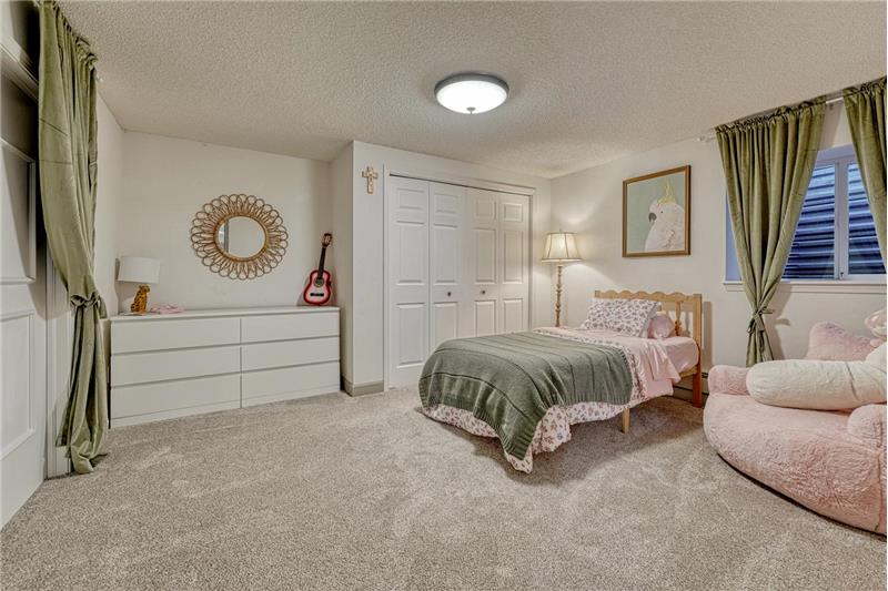 Basement Bedroom #5 has neutral carpet and  generous double closets.