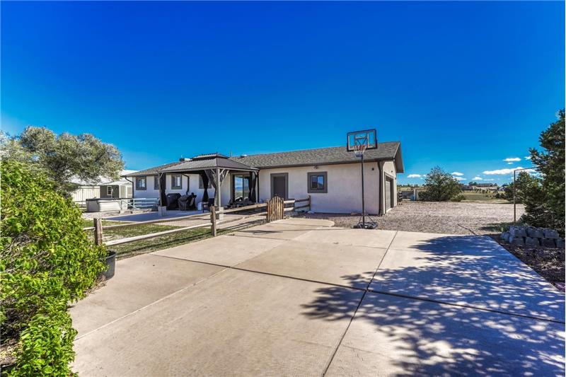 Backyard concrete driveway for additional parking.