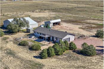 Aerial view of home and out buildings.