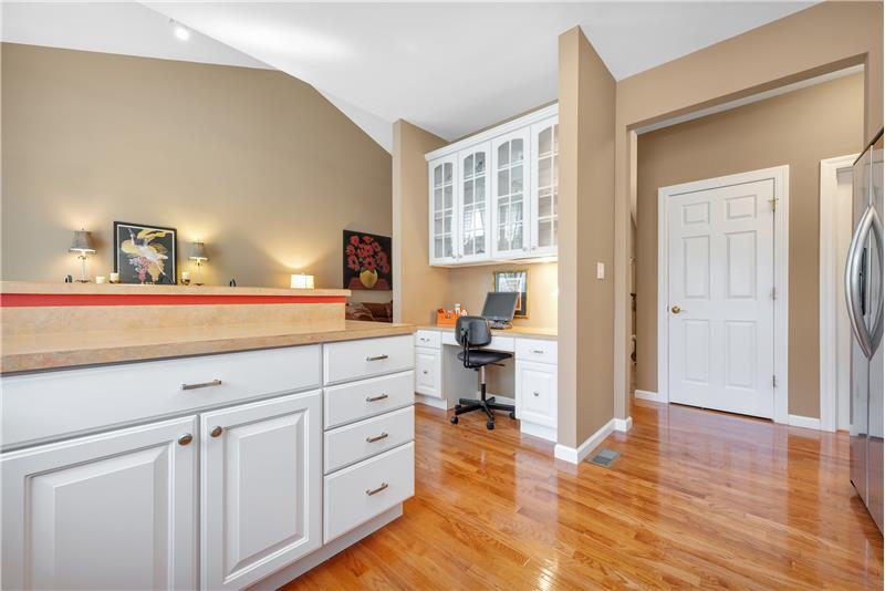 Planning desk with glass front cabinets in the kitchen