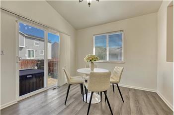 Walk Out Dining Area with wood laminate flooring.