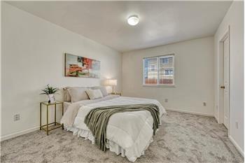 Primary Bedroom with new carpet, a walk in closet, and adjoining bathroom.