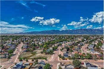 Aerial view of neighborhood and surrounding mountains.