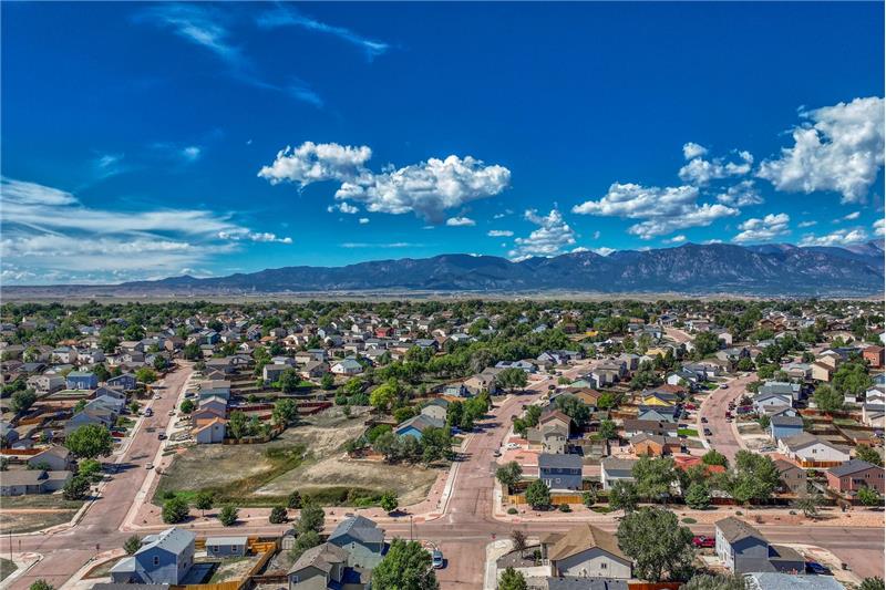 Aerial view of neighborhood and surrounding mountains.