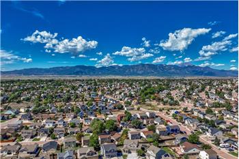 Aerial view of community and surrounding mountains.