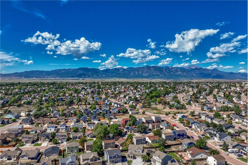 Aerial view of community and surrounding mountains.
