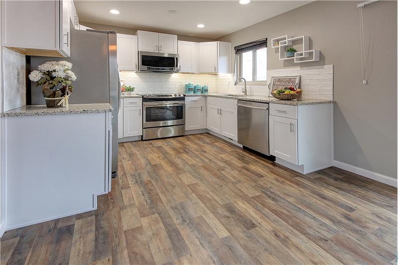 Updated kitchen with new granite counter tops, new cabinets and new tile backsplash!