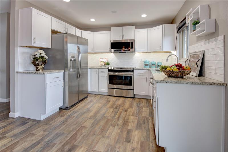Stainless steel appliances, recessed lighting, and under cabinet lighting