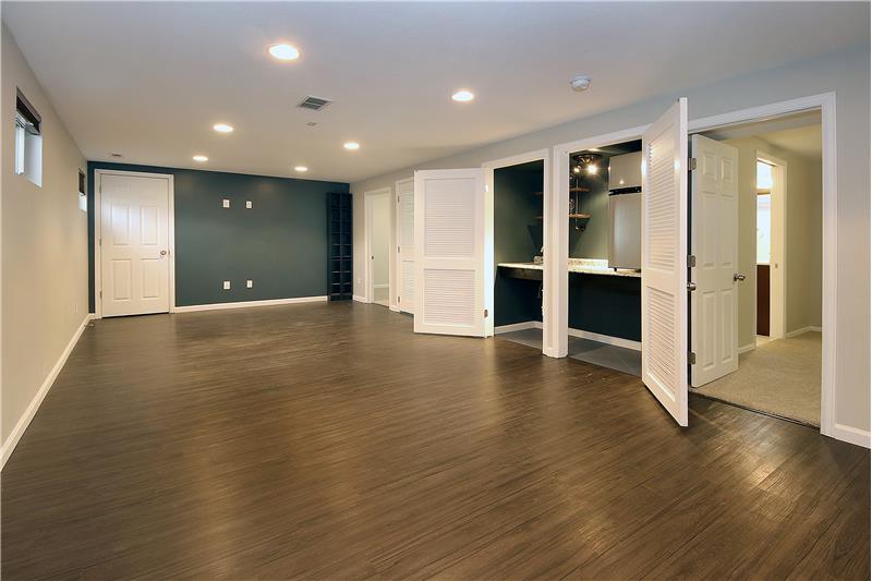 Enormous family room in basement. Back wall has wiring for a T.V. and door to 3x10 storage area