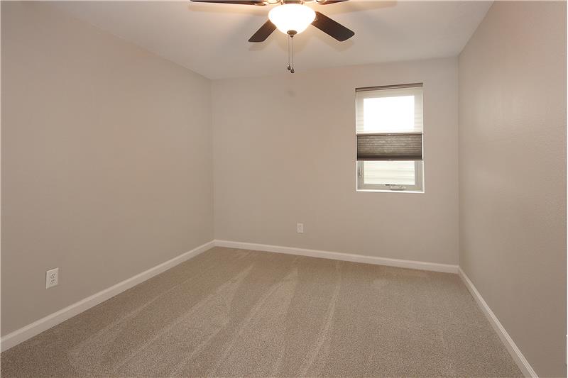 Bedroom 5 with new carpet and ceiling fan