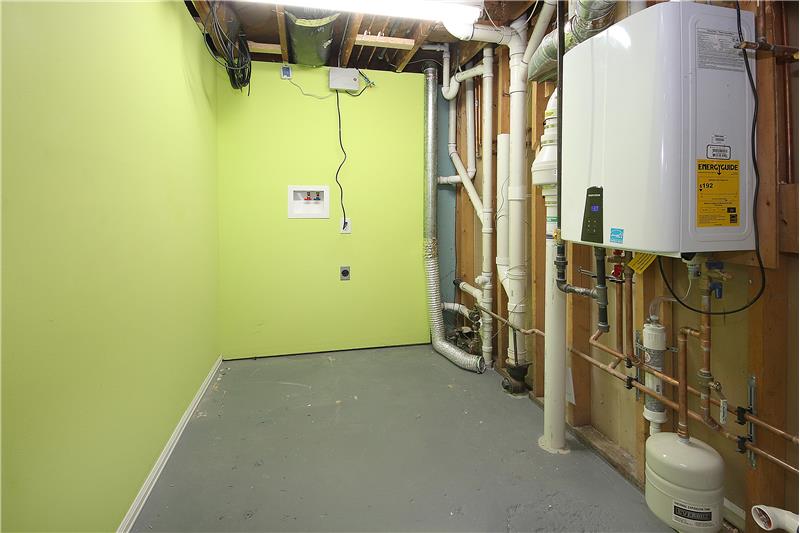 Large laundry room and mechanical room.  New Tankless water heater!