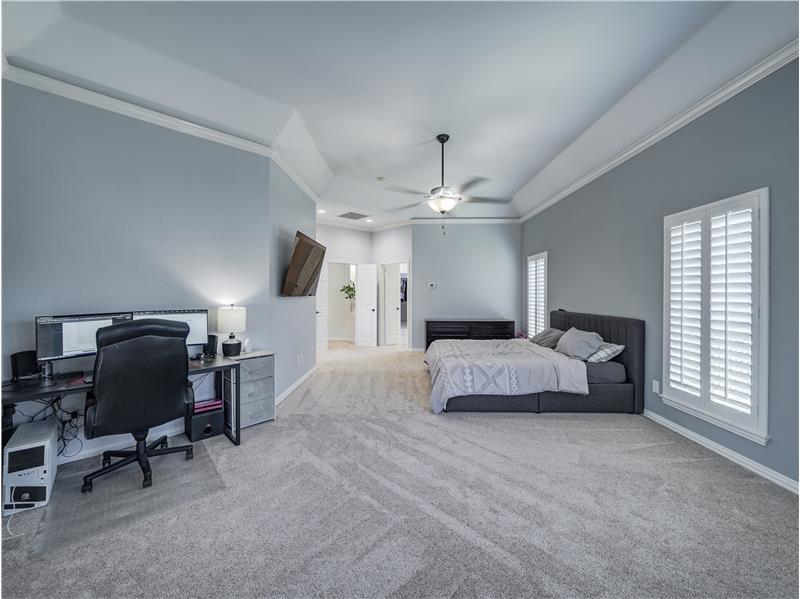 Oversized primary bedroom with plantation shutters