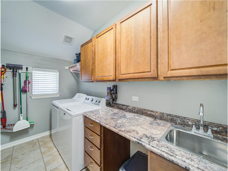 Large laundry room with cabinets, sink