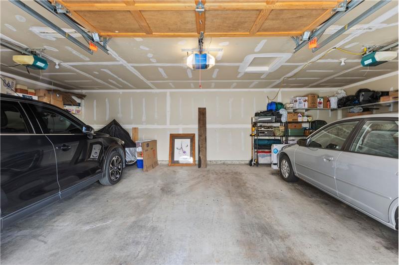 Shared garage with plenty of room for storage on the back wall.