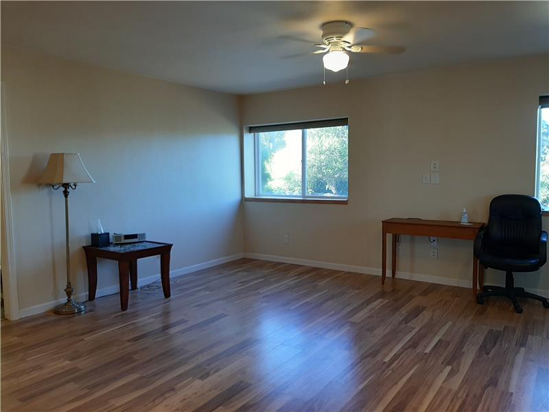 The Great Room Design & Natural Light Works Well with the Wood Laminate Flooring!