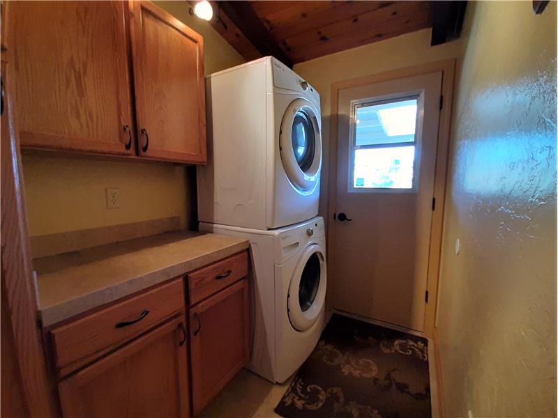 Large Utility Room includes space for folding clothes, cabinets, cupboards, closet and access to Tankless Water Heater!
