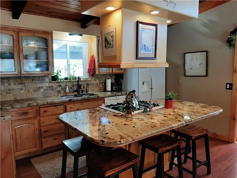 Granite Counters, Overhead Venting and Recessed Lighting makes for a Dramatic Center Island!