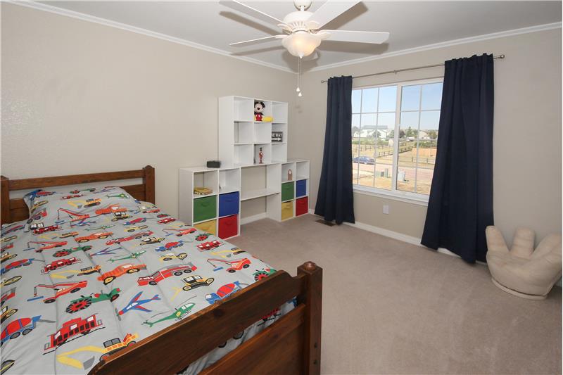 Bedroom 3 with ceiling fan and crown moulding