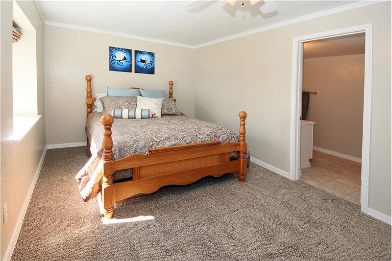 Bright bedroom 4 with crown moulding, ceiling fan, and an adjoining full bath, is great for guests!
