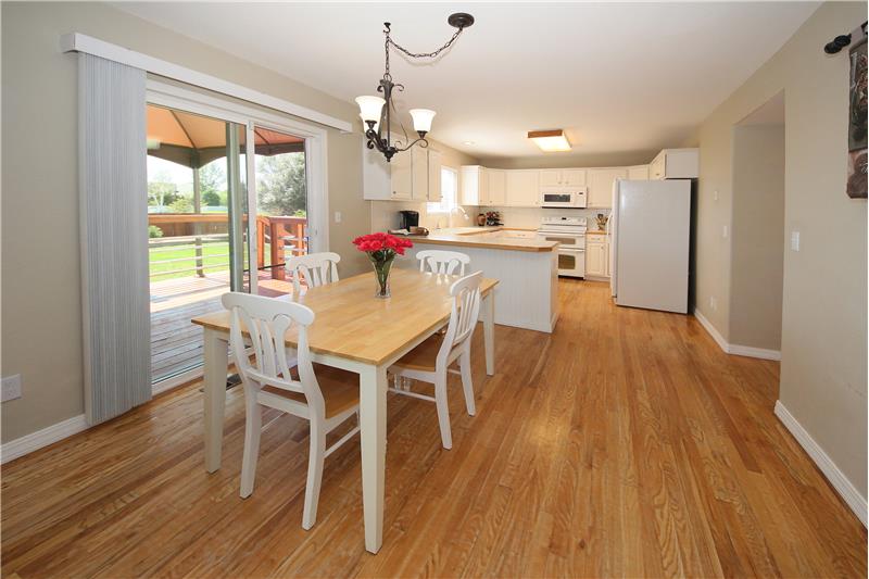 Dining area with hardwood floor provides a walk-out to back deck