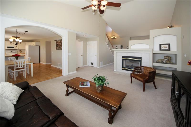 Spacious family room with gas fireplace and built-in shelving