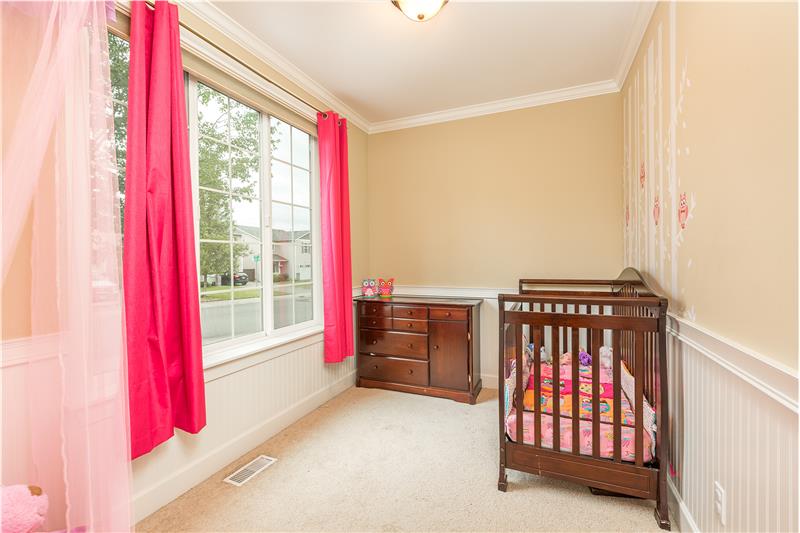 Main Floor Den with Crown Molding and Chair Rail. Currently being used as a Nursery.