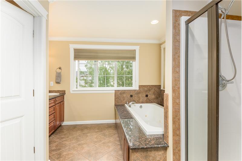 Private Master Bathroom, with Granite Counter Tops, Jetted Tub and Tile Floors.