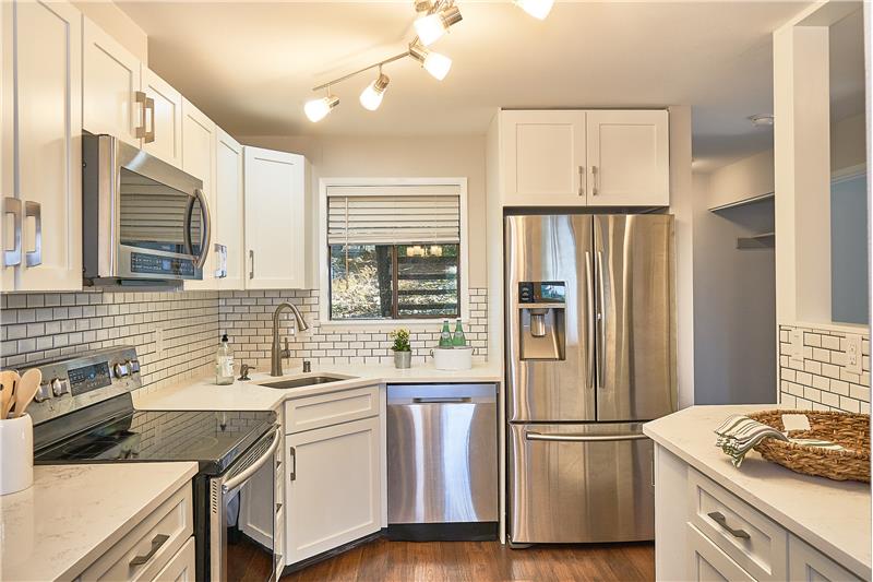 Pride of Ownership Throughout this Remodeled, Private End Unit 2 bedroom and 2 bathroom ADA Condo. Gorgeous Remodeled Kitchen wi