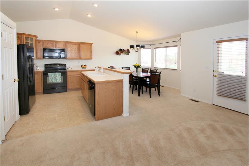 Kitchen with vaulted ceilings and recessed lighting