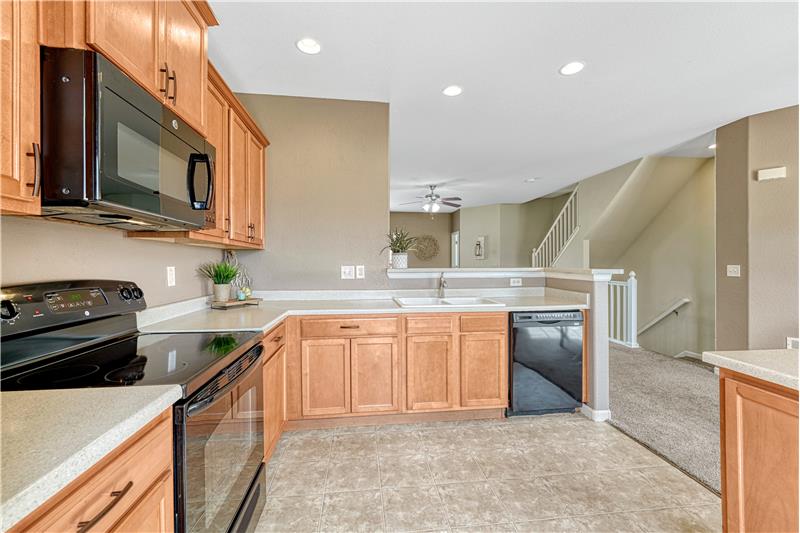 Recessed lighting, window in kitchen, and counter bar