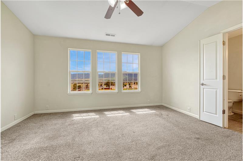 Primary Bedroom #2 with vaulted ceilings, adjoining full bath, walk-in closet, and stunning mountain views!