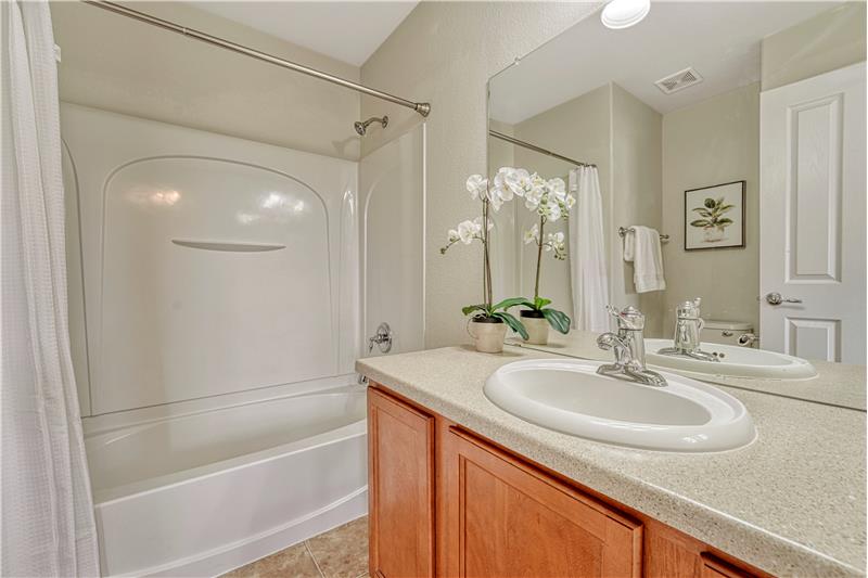 Adjoining bath to Primary Bedroom #1 with tub/shower combo and medicine cabinet