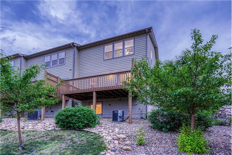 Rear view of townhome and rear deck